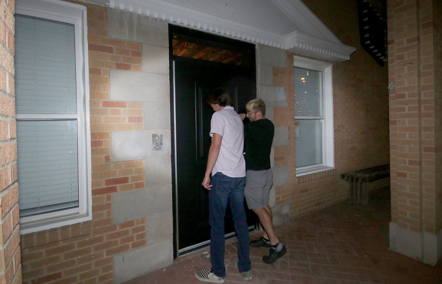 Protesters bang on the door of the Phi Gamma Delta Fraternity
